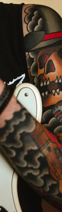 A black and grey sleeve concept: a viking, a raven and a pine treeline under runes.