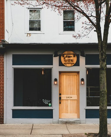Umeko Sushi's black storefront and wooden door at 418 Bank Street.