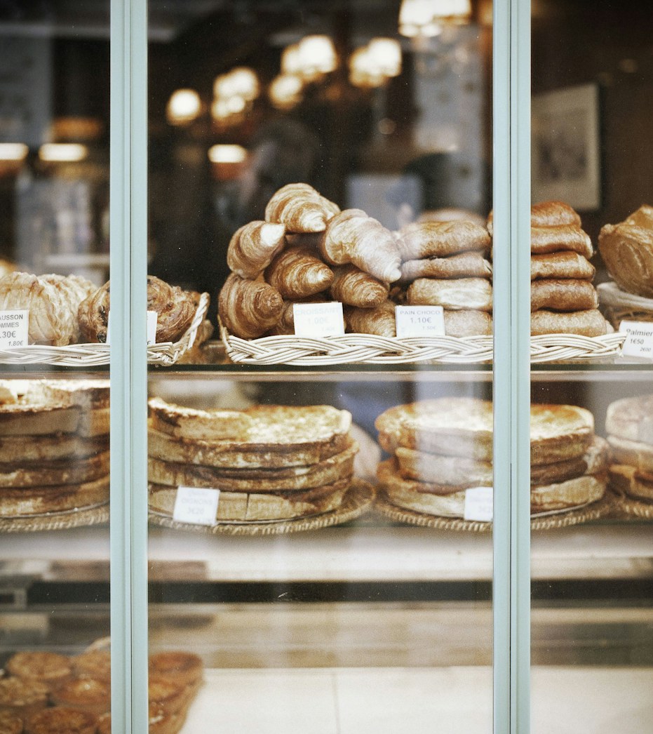 The glass counter lined with pastries