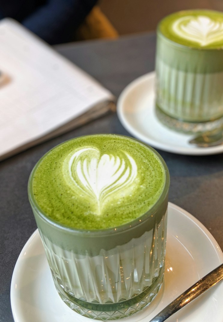 A matcha latte in a ribbed glass