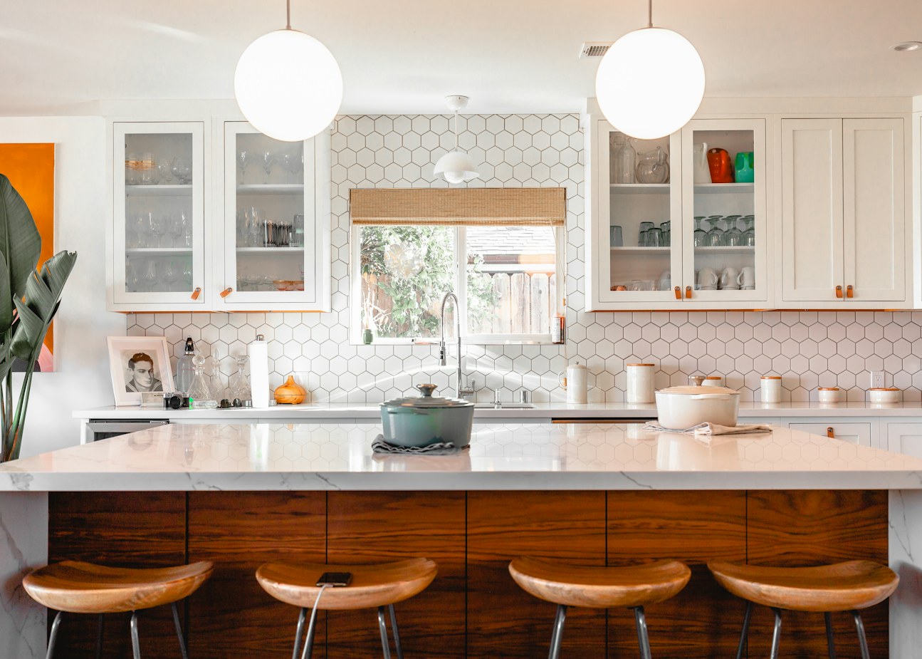 Completed kitchen with new cabinetry, a walnut-clad island and hex backsplash