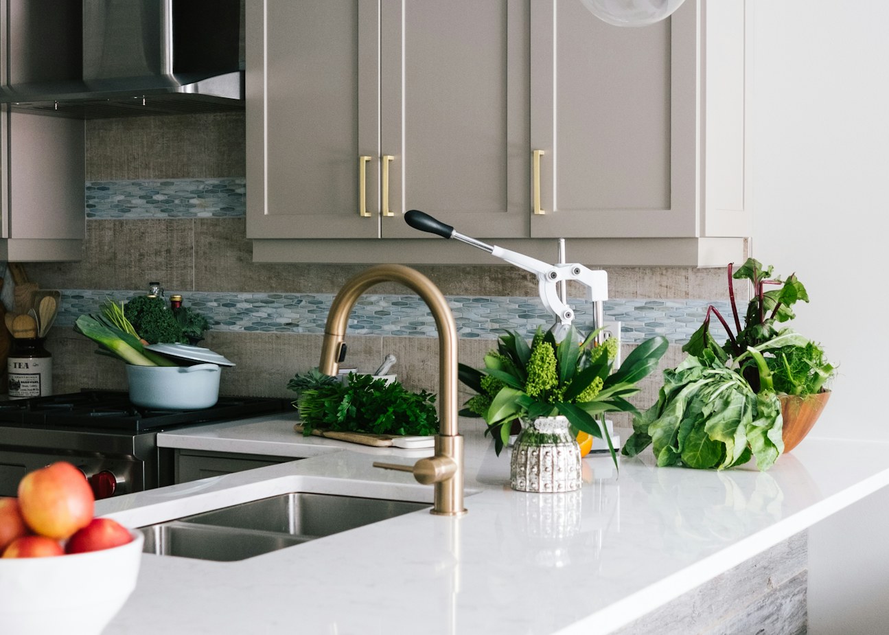 Kitchen run with marble-look counter, undermount sink and brass gooseneck faucet